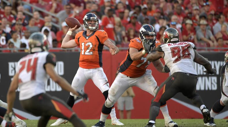 Denver Broncos quarterback Paxton Lynch (12) throws a pass as offensive guard Michael Schofield (79) blocks Tampa Bay Buccaneers defensive tackle Clinton McDonald (98) during the second half of an NFL football game in Tampa, Fla., Sunday, Oct. 2, 2016. The Broncos won 27-7. (AP Photo/Phelan M. Ebenhack)