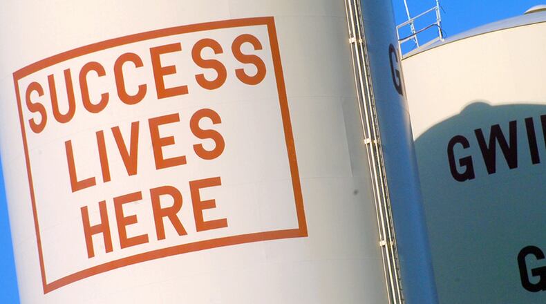 These water tanks -- bragging about Gwinnett County -- used to tower over Jimmy Carter Boulevard. FILE / AJC STAFF