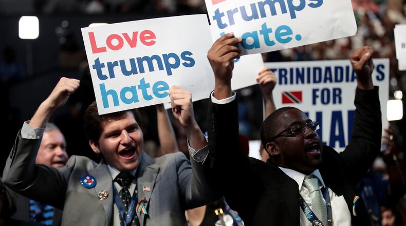PHILADELPHIA, PA - JULY 25: Delegates hold up signs that read "Love trumps hate" during the opening of the first day of the Democratic National Convention at the Wells Fargo Center, July 25, 2016 in Philadelphia, Pennsylvania. An estimated 50,000 people are expected in Philadelphia, including hundreds of protesters and members of the media. The four-day Democratic National Convention kicked off July 25. (Photo by Drew Angerer/Getty Images)