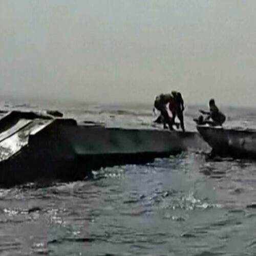 In this image taken from a video people are rescued from an overloaded ferry that capsized on Zimbabwe's Lake Kariba on Tuesday, Aug. 11, 2026. (Maxton Kanhema via AP)