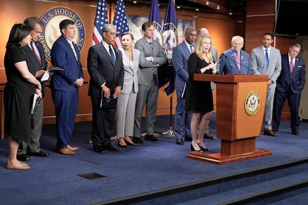 Rep. Madeleine Dean, D-Pa., center, speaks during a news conference at the U.S. Capitol, Wednesday, July 2, 2025, in Washington. (AP Photo/Mariam Zuhaib)