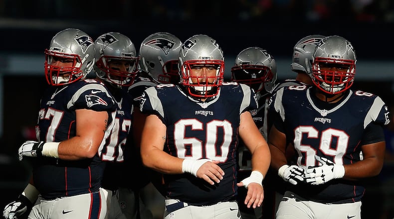 Patriots center David Andrews (60) and guard Shaq Mason (69) are side by side, ready in this case for a second half against Dallas last season. (Christian Petersen/Getty Images)