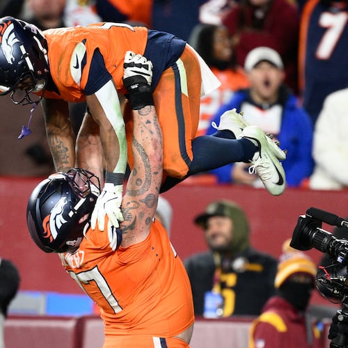 Denver Broncos running back RJ Harvey, is lifted by teammate Quinn Meinerz after scoring during overtime of an NFL football game against the Washington Commanders Sunday, Nov. 30, 2025, in Landover, Md. (AP Photo/Nick Wass)