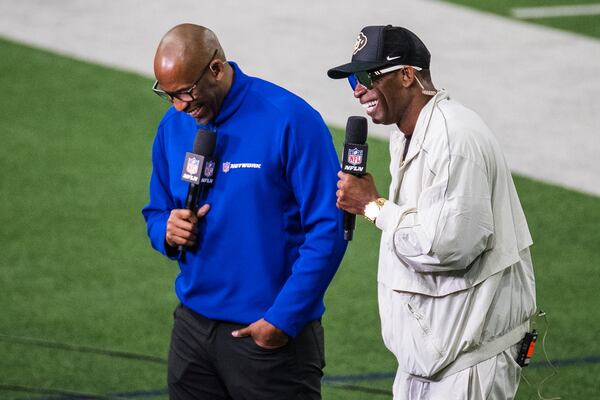 Colorado State head coach Deion Sanders is interviewed by NFL Network's Bucky Brooks during the Big 12 Conference's NFL football pro day Thursday, March 20, 2025, in Frisco, Texas. (AP Photo/Jessica Tobias)