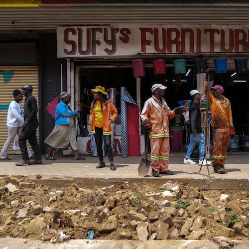 Workers fix a road in Johannesburg's Soweto township as a massive cleanup job gets underway in anticipation of the upcoming G20 summit to be held in the South African economic capital, Friday, Nov. 14, 2025. (AP Photo/Jerome Delay)