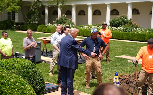 President Donald Trump looks over a construction project in the Rose Garden of the White House, after his arrival, Monday, June 9, 2025, in Washington. (AP Photo/Evan Vucci)