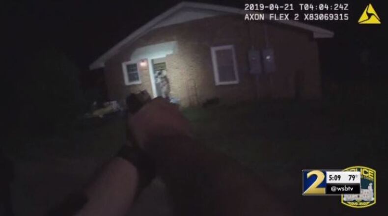 Body camera footage shows the moment a man opened the door to his home and pointed a gun at an Athens police officer.