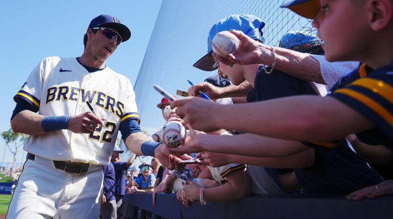 Milwaukee Brewers' Christian Yelich signs autographs prior to a spring training baseball game against the Los Angeles Dodgers Monday, March 9, 2026, in Phoenix. (AP Photo/Ross D. Franklin)