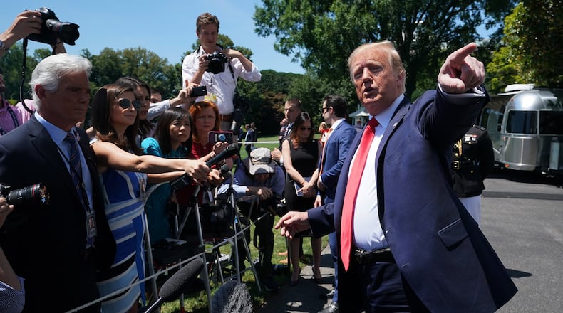 President Donald Trump stops to briefly talk with journalists at the White House on Monday, one day after tweeting that four Democratic congresswomen of color should go back to their own countries. Chip Somodevilla/Getty Images