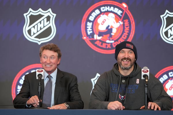 Former NHL player Wayne Gretzky, left, with Washington Capitals Alex Ovechkin, right, during a press conference after an NHL hockey game in which Ovechkin tied Gretzky's NHL career goals record of 894th goals, Friday, April 4, 2025, in Washington.(AP Photo/Mark Schiefelbein)