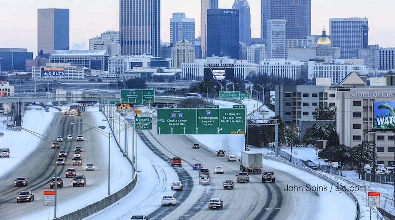 Traffic built on the Downtown Connector on a snowy Wednesday morning.