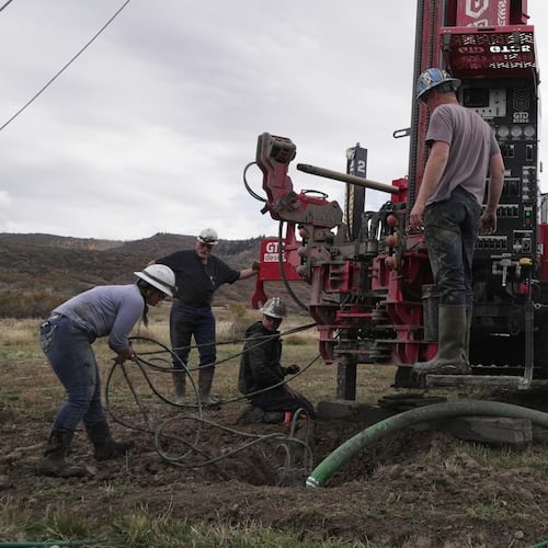 Matt Cooper and his kids Anna, Nathan and Matthew prepare to drill a hole for a geothermal heat pump installation Thursday, Oct. 9, 2025, in Hamilton, Colo. (AP PhotoBrittany Peterson)