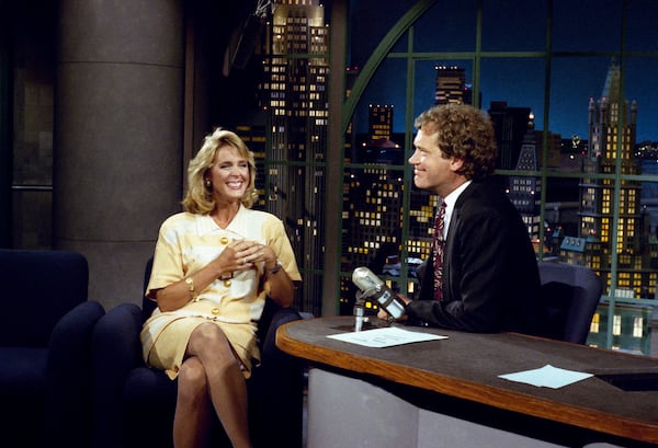 Then-NBC "Today" show co-anchor Deborah Norville visits with host David Letterman during "Late Night with David Letterman" on Sept. 5, 1990, in New York. (AP File)