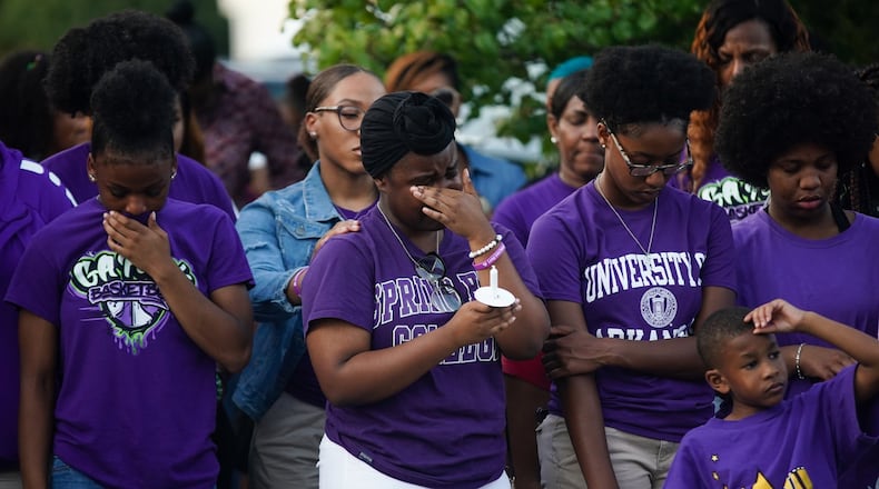 Friends and teammates of Imani Bell become emotional during Wednesday candlelight vigil in Jonesboro. Bell collapsed and died while doing outdoor athletic drills in extreme heat. ELIJAH NOUVELAGE/SPECIAL TO THE AJC
