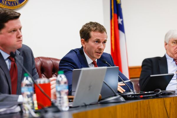 State Sen. Greg Dolezal (center) questions Jeff DiSantis (not pictured), aide to Fulton County District Attorney Fani Willis, during a Senate committee hearing. (Arvin Temkar/AJC)