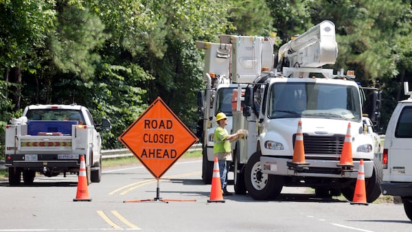 Utility crews work to restore lines that were knocked down on Estes Drive during tropical storm Chantal, Monday, July 7, 2025, in Chapel Hill, N.C. (AP Photo/Chris Seward)