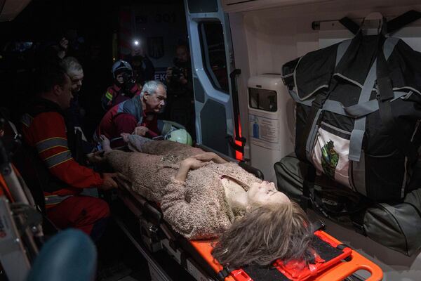 Medics tend to an injured woman in an ambulance near a house destroyed by a Russian airstrike in a residential neighbourhood in Kyiv, Ukraine, on Thursday, April 24, 2025. (AP Photo/Evgeniy Maloletka)