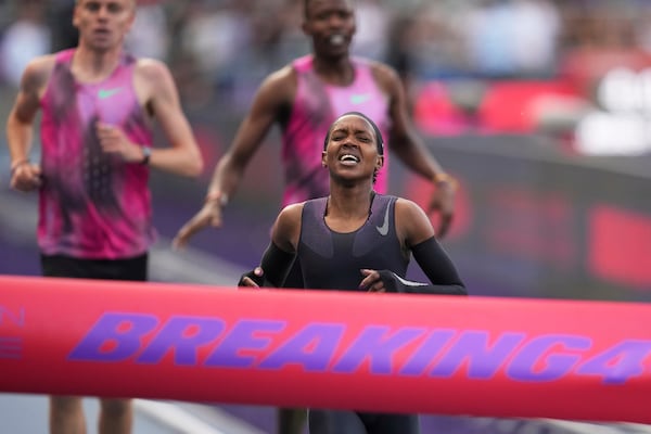 Faith Kipyegon, from Kenya, approaches the finish line in her attempt to become the first woman to run a mile in under four minutes, at Stade Charlety in Paris, Thursday, June 26, 2025. (AP Photo/Christophe Ena)