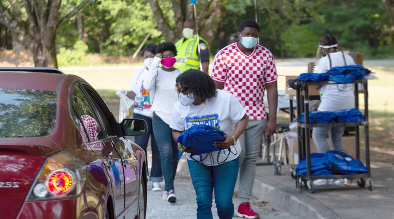 Volunteers hand out free backpacks and other schools supplies at Kemp Elementary Saturday morning in Hampton, Georgia, on August 8, 2020. STEVE SCHAEFER FOR THE ATLANTA JOURNAL-CONSTITUTION