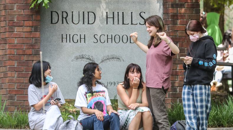 Students wait outside Druid Hills High School on May 5, 2022, in DeKalb County. (John Spink/AJC)
