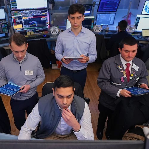 Niall Pawa, foreground center, works with fellow traders on the floor of the New York Stock Exchange, Monday, June 1, 2026. (AP Photo/Richard Drew)