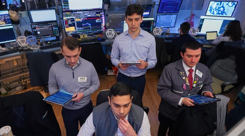 Niall Pawa, foreground center, works with fellow traders on the floor of the New York Stock Exchange, Monday, June 1, 2026. (AP Photo/Richard Drew)