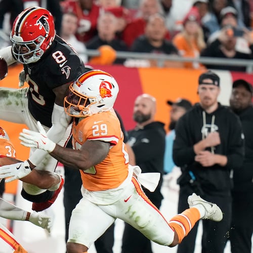 Atlanta Falcons tight end Kyle Pitts Sr. (8) leaps over Tampa Bay Buccaneers safety Christian Izien (29) during the first half of an NFL football game, Thursday, Dec. 11, 2025, in Tampa, Fla. (AP Photo/Chris O'Meara)