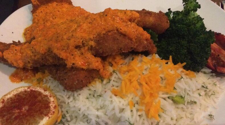 Mulavi’s sabzi polo mahi (fried fish) is served with baghali polo (rice with dill and favas). CONTRIBUTED BY WENDELL BROCK