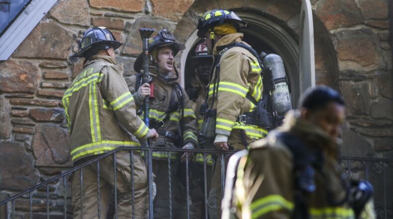 The two-alarm blaze started in the basement of the three-story house on Crestridge Drive. JOHN SPINK / JSPINK@AJC.COM