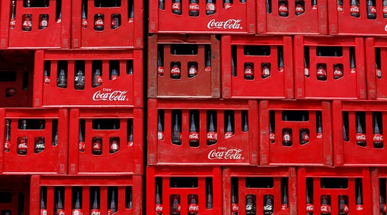 Three long-time Coca-Cola directors are stepping down Thursday.