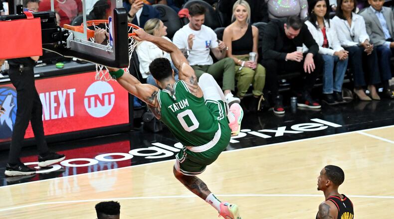 Celtics forward Jayson Tatum hangs on the basket after dunking the ball at the end of the fourth quarter in Game 4 of the first round of the Eastern Conference playoffs at State Farm Arena, Sunday, April 23, 2023, in Atlanta. The Celtics beat the Hawks 129-121. (Hyosub Shin / Hyosub.Shin@ajc.com)
