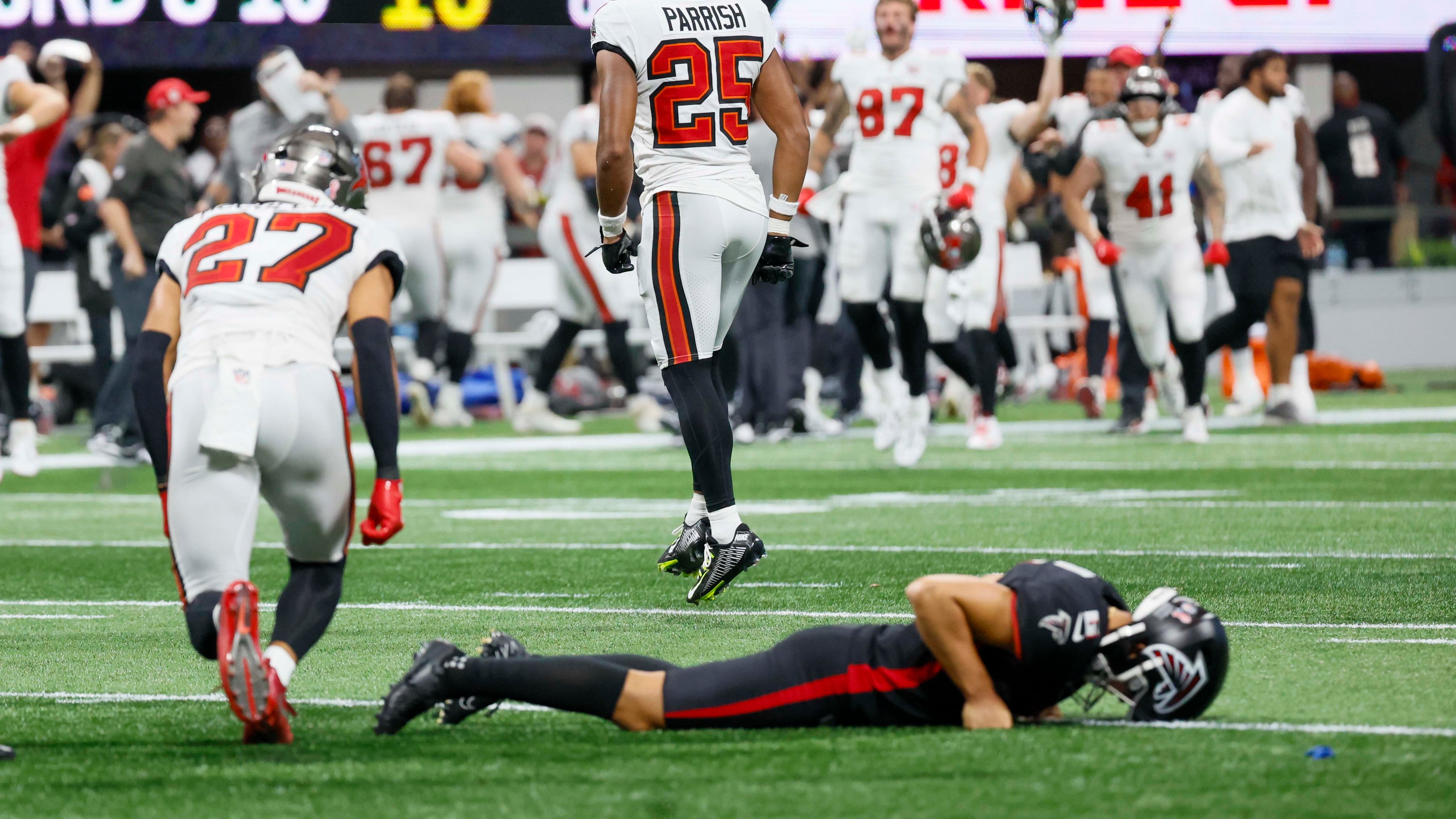 Tampa Bay Buccaneers players celebrate as Atlanta Falcons placekicker Younghoe Koo (6) lies on the ground after missing a last-second field goal. The Atlanta Falcons lost their home opener 23-20 to the Tampa Bay Buccaneers at Mercedes-Benz Stadium on Sunday, September 7, 2025, in Atlanta. 
(Miguel Martinez/ AJC)