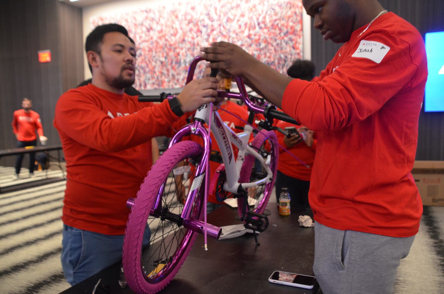 Delta volunteers assemble 100 bicycles to donate to kids