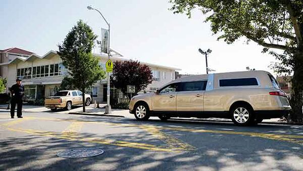 A gold colored hearse carrying the coffin bearing the body of Bobby Kristina Brown arrives at Whigham Funeral home in Newark, N.J., early Monday, Aug. 3, 2015. (AP)