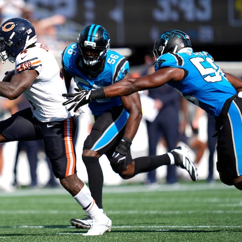 Chicago Bears running back D'Andre Swift (4) runs against Carolina Panthers linebacker Jeremiah Moon (56) and inside linebacker Bobby Okereke (58) to score a touchdown during the second half of an NFL football game, Sunday, Sept. 13, 2026, in Charlotte, N.C. (AP Photo/Erik Verduzco)