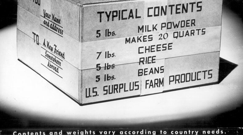 The typical contents of a CARE Package included 5 pounds of milk powder, 7 pounds of cheese, 5 pounds of rice and 5 pounds of beans. AJC file