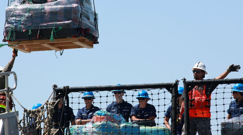 SAN DIEGO, CA - APRIL 16: Coast Guard personel stand aboard the USS Boutwell while officials unload bails of cocaine caught at sea while on deployment on April 16, 2015 at Naval Base San Diego in San Diego, California. Officials from the United States and Canada seized over 28,000 pounds of cocaine while on patrol in the Eastern Pacific which resulted in a record seizure.(Photo by Sandy Huffaker/Getty Images)