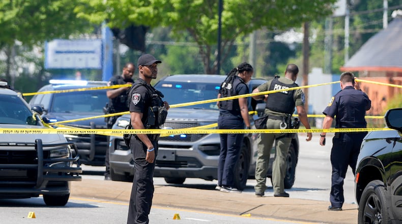 Multiple agencies are at the scene where two police officers were shot Friday on Fulton Industrial Boulevard. (Ben Hendren for the Atlanta Journal-Constitution)