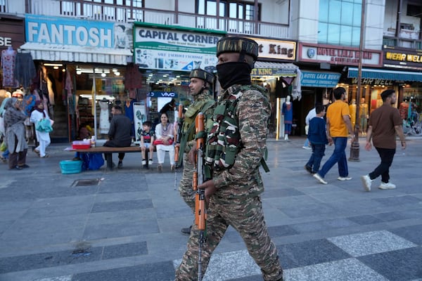 Indian paramilitary soldiers patrol as they guard at a busy market in Srinagar, Indian controlled Kashmir, Tuesday, April 29, 2025. (AP Photo/Mukhtar Khan)