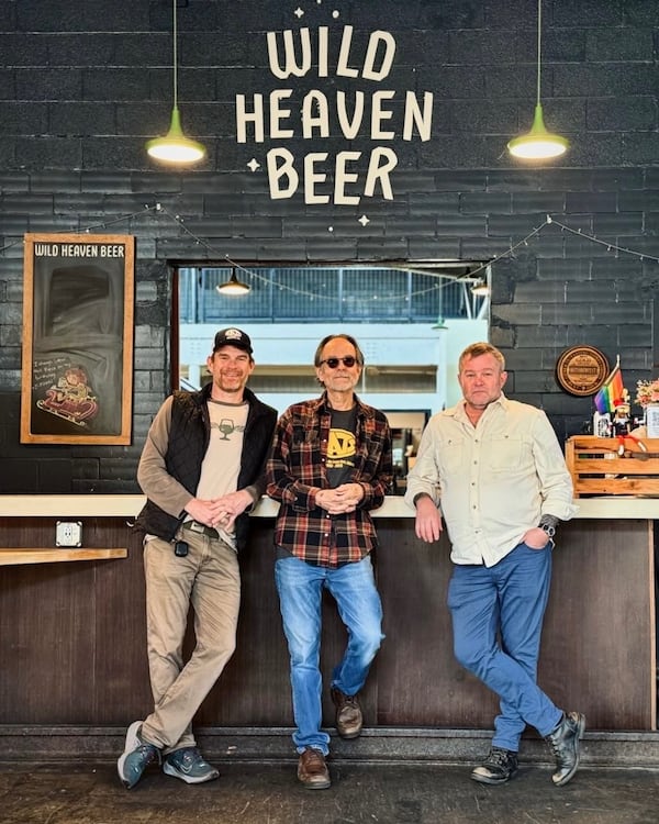 Wild Heaven Beer's co-owners Nick Purdy (far left) and Eric Johnson (far right) have purchased Eats from original owner Bob Hatcher (center). (Courtesy of Courtney DiCarlo)