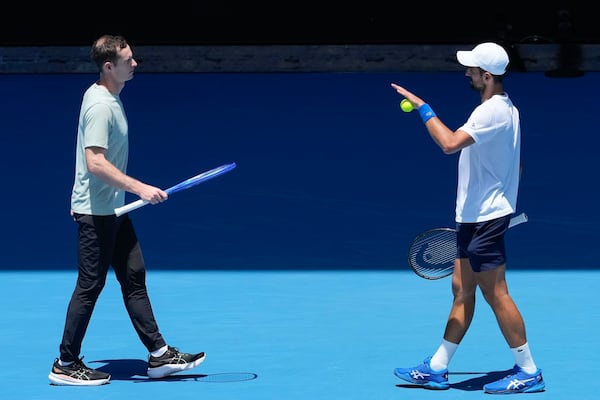 FILE - Serbia's Novak Djokovic talks with his coach Andy Murray, left, during a practice session ahead of the Australian Open tennis championship in Melbourne, Australia, Saturday, Jan. 11, 2025. (AP Photo/Manish Swarup, file)