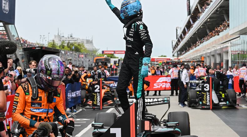 Mercedes driver George Russell, of Britain, waves after winning the sprint race at the F1 Canadian Grand Prix auto race in Montreal, Saturday, May 23, 2026. (Graham Hughes/The Canadian Press via AP)