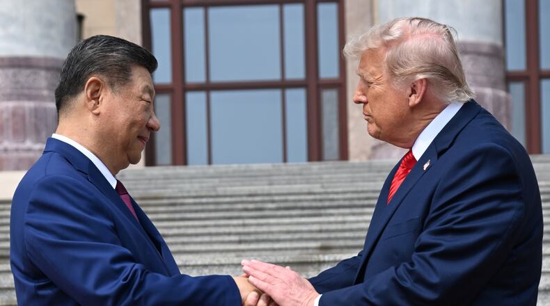 FILE - Chinese President Xi Jinping, left, shakes hands with President Donald Trump at the Great Hall of the People in Beijing, May 14, 2026. (Kenny Holston/Pool Photo via AP, file)