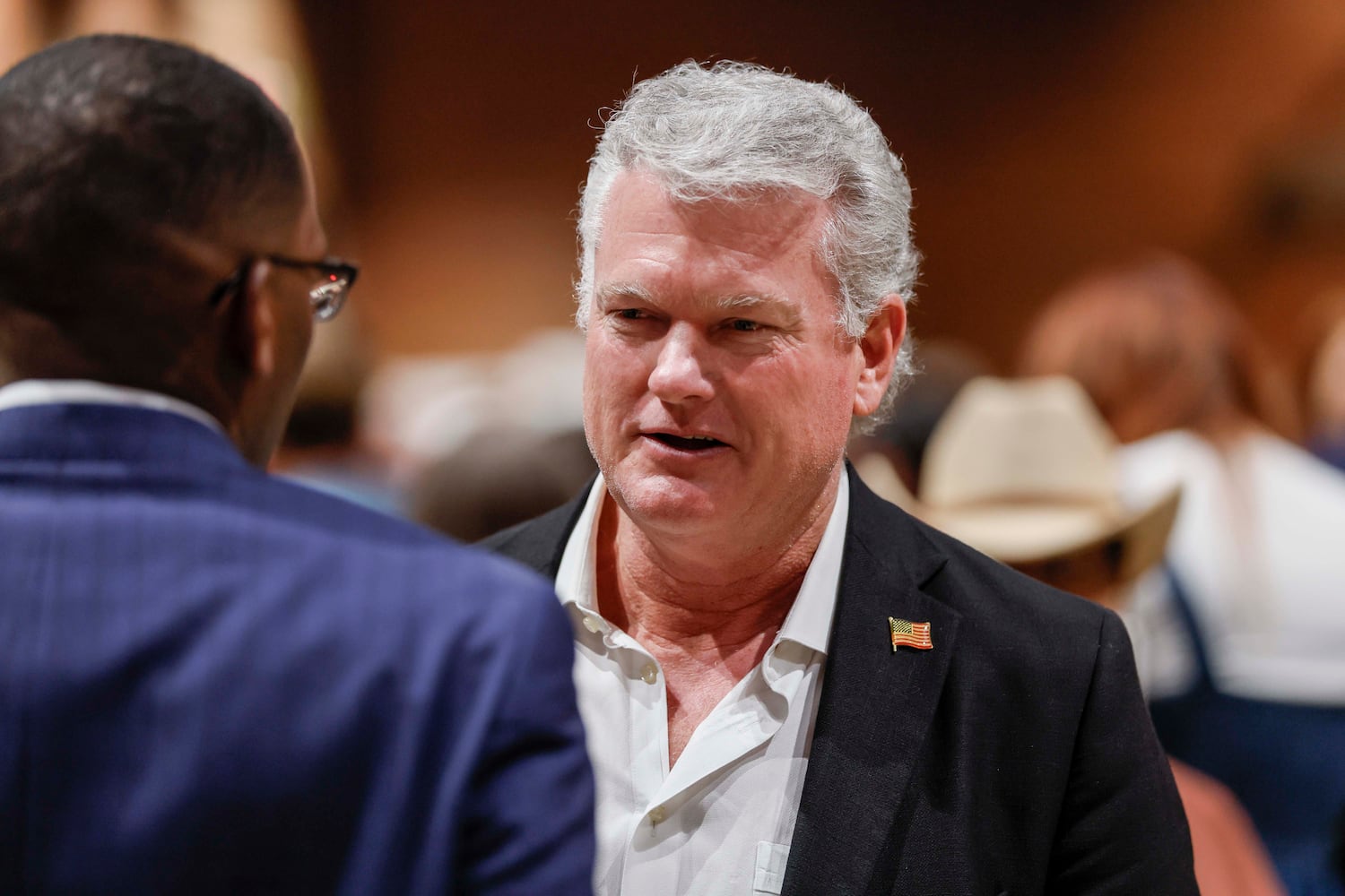 U.S. Rep. Mike Collins, R-Jackson, speaks with an attendee at the event. (Miguel Martinez/AJC)