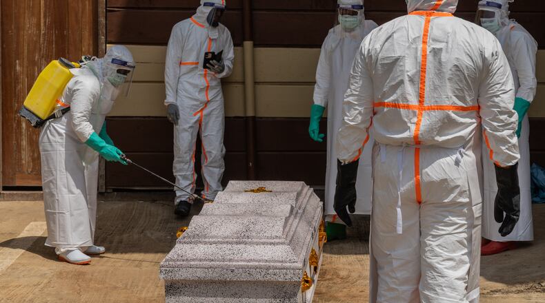 Health workers prepare the coffin of Angèle Muyumba Nsimire, a university student who died of Ebola at the Citadelle Clinic in Bunia, Congo, Friday, June 12, 2026. (AP Photo/Moses Sawasawa)