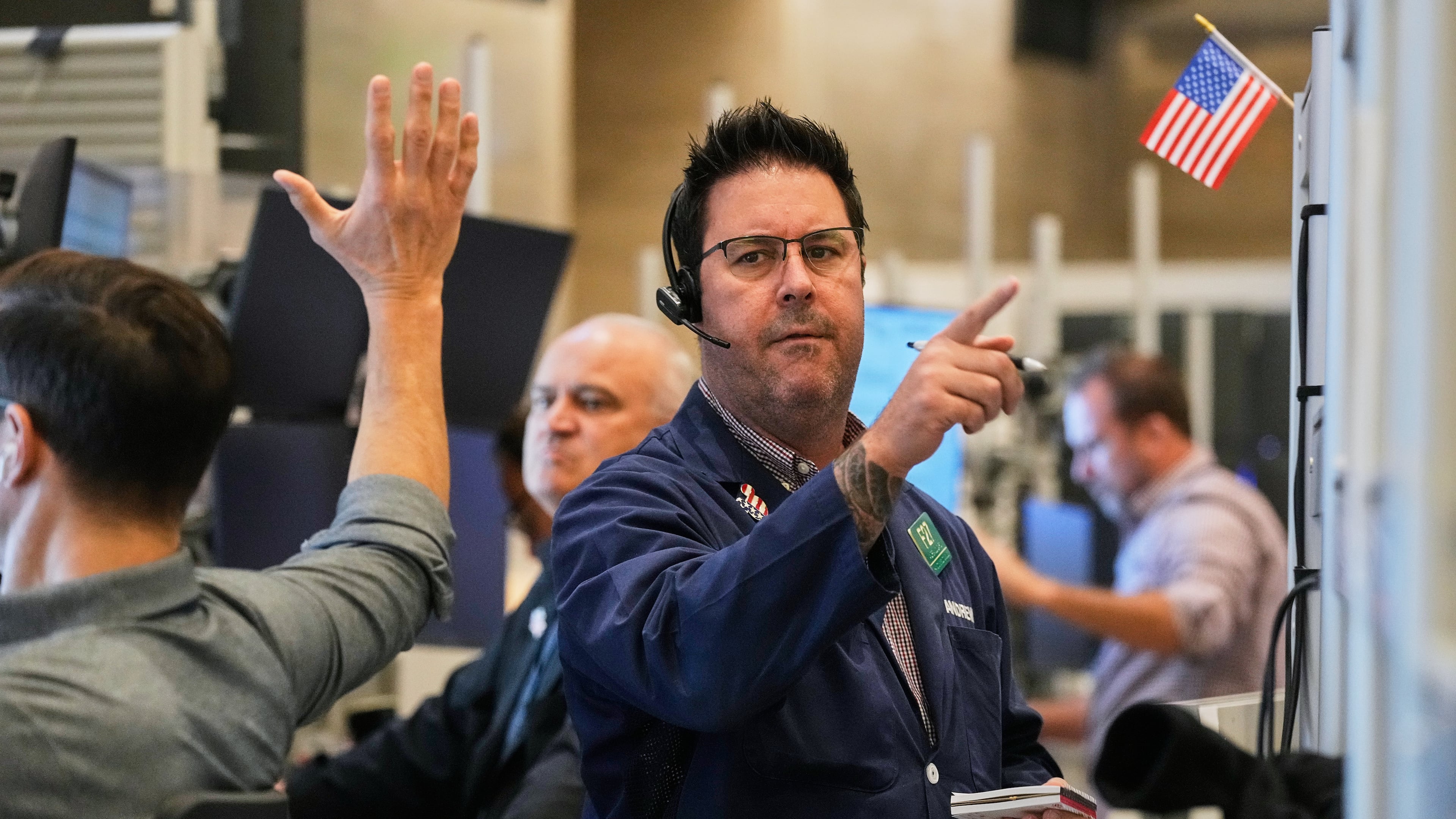 Options trader Andrew Longer, right, works on the floor of the New York Stock Exchange, Wednesday, Oct. 15, 2025. (AP Photo/Richard Drew)