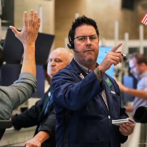 Options trader Andrew Longer, right, works on the floor of the New York Stock Exchange, Wednesday, Oct. 15, 2025. (AP Photo/Richard Drew)