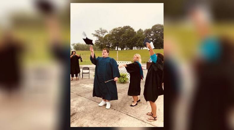 Jordan Smith celebrates during his private graduation ceremony at Spalding HIgh School in Griffin.