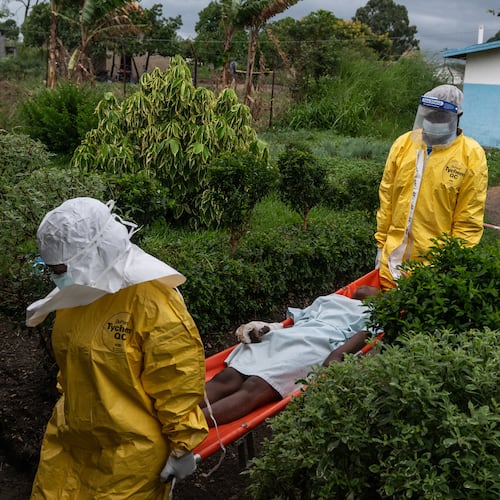 FILE - Medical staff carry an Ebola patient to a treatment center in Rwampara, Congo, Thursday, May 21, 2026. (AP Photo/Moses Sawasawa, file)