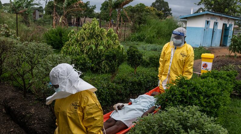 FILE - Medical staff carry an Ebola patient to a treatment center in Rwampara, Congo, Thursday, May 21, 2026. (AP Photo/Moses Sawasawa, file)
